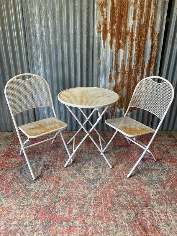 A midCentury style mesh garden set table and two chairs Belle and
