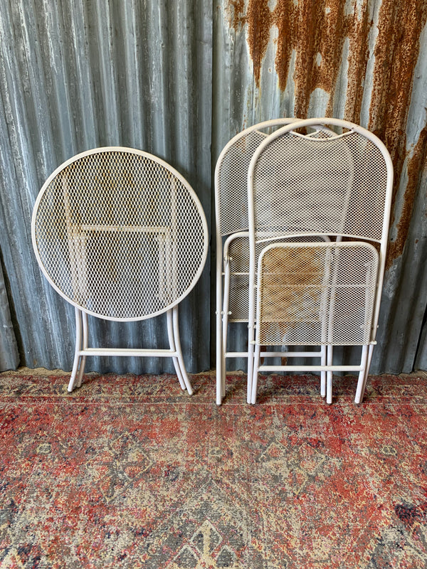 A midCentury style mesh garden set table and two chairs Belle and
