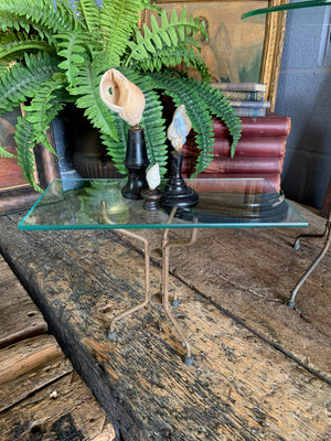 A set of four metal displays stands with interchangeable glass tops