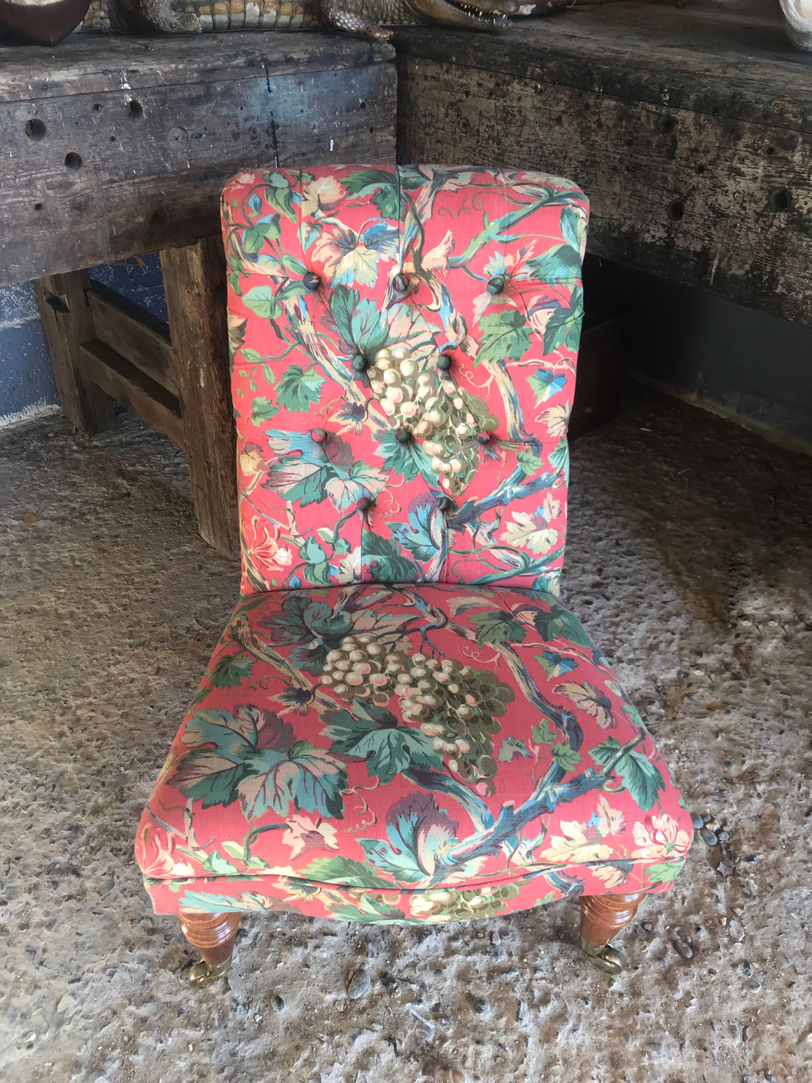 A 'country house' button back nursing chair with brass castors