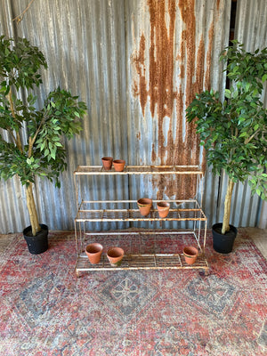 A white cast iron plant stand