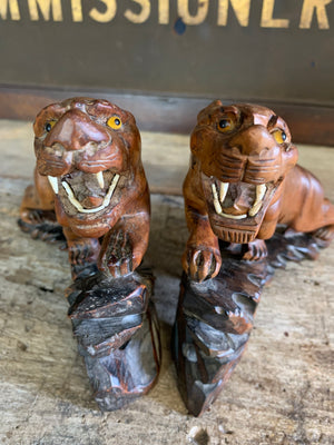 An opposing pair of carved Chinese rosewood tigers