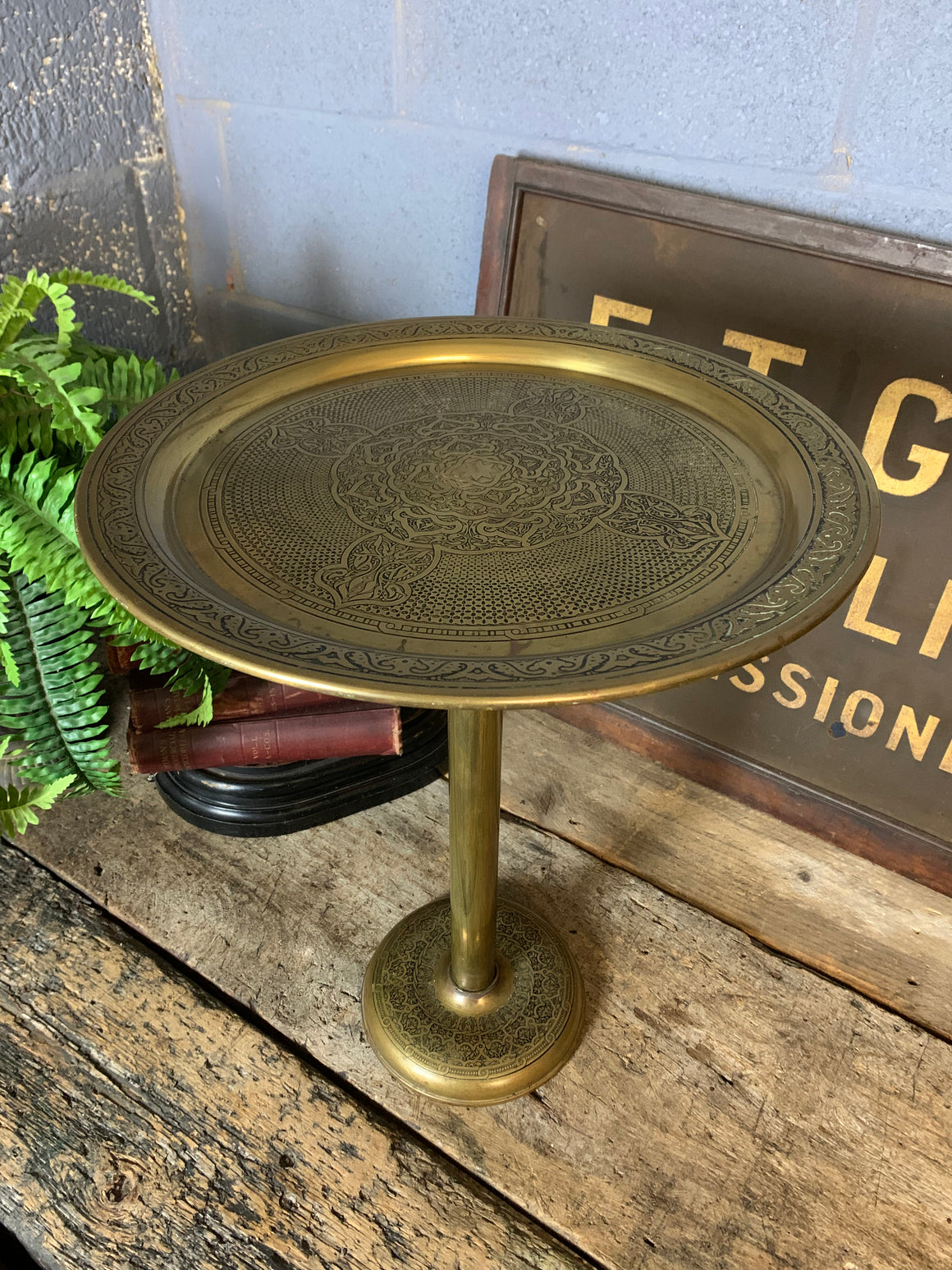 An ornate brass Anglo-Indian pedestal table