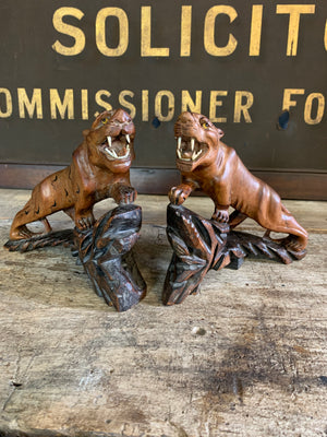 An opposing pair of carved Chinese rosewood tigers