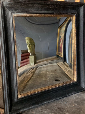 A single wooden ebonised convex distortion mirror
