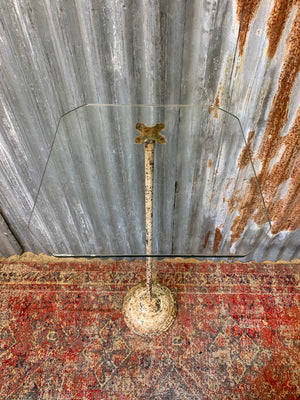 A large cast iron and glass shop display stand