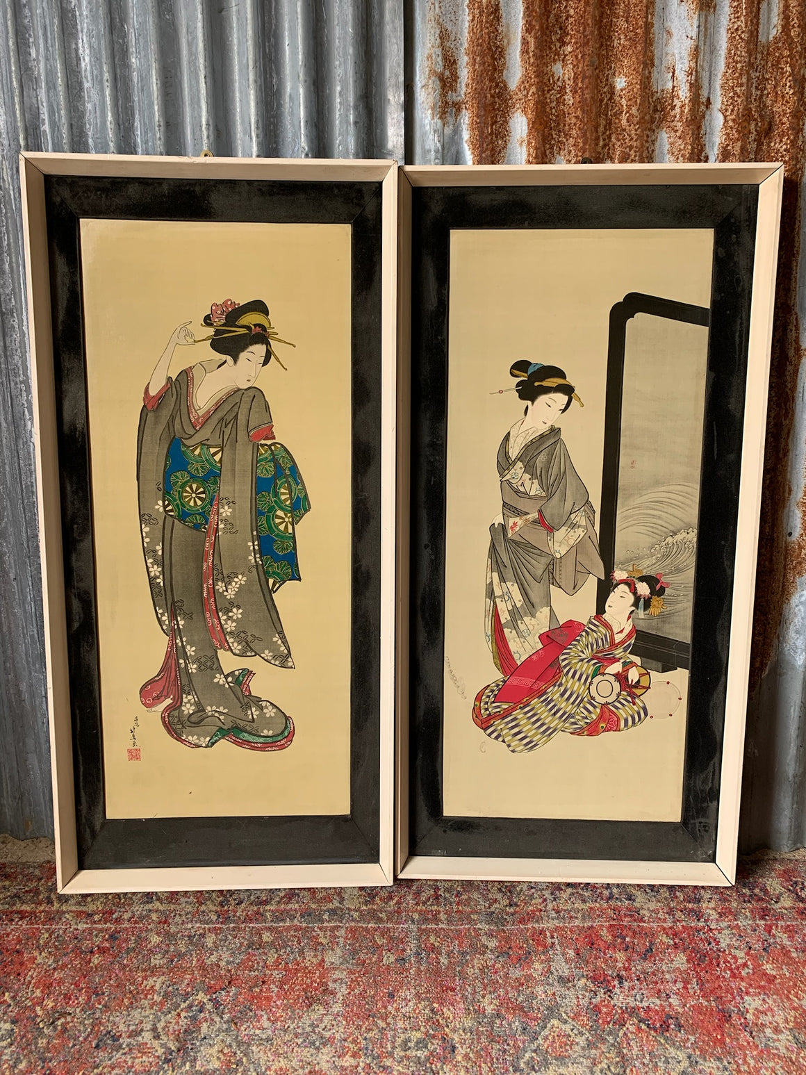 A pair of framed Japanese geisha pictures