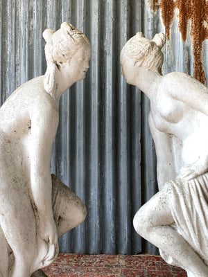 A pair of cast stone Pandora statues