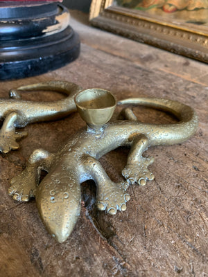 A pair of brass candlesticks in the form of lizards