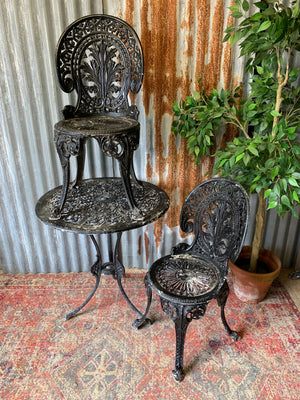 A black garden table and chairs set