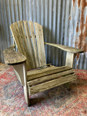 A wooden Adirondack chair and ottoman