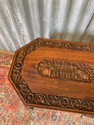 A carved wooden elephant table