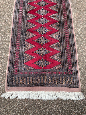 A long pink ground Persian runner rug ~ 318cm x 83cm