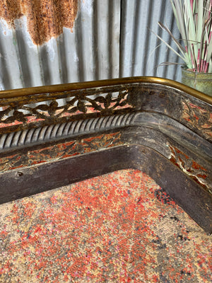 A large Victorian brass fender with lion paw feet
