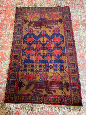 A Persian or Kurdish red ground pictorial rug - 165cm x 92cm