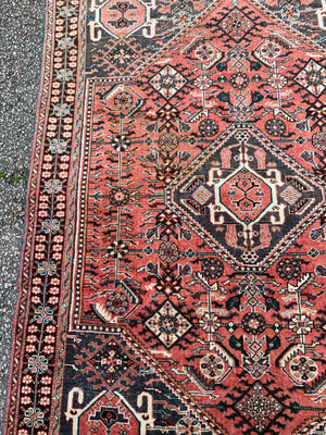 A Persian red ground rectangular rug- 161cm x 117cm