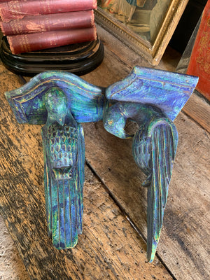 A pair of wooden corbels in the form of parrots