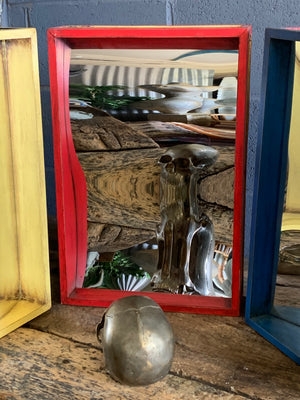 A wooden fairground distortion mirror - red, yellow or blue