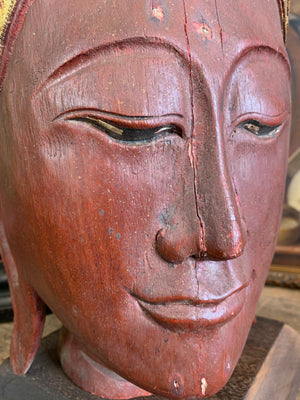 A carved wooden Buddha head