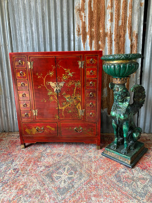 A red and gold lacquered chinoiserie cabinet