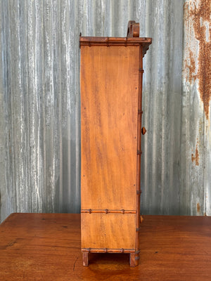 A small French faux bamboo mirrored cabinet