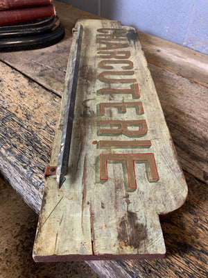 A French ‘charcuterie’ sign with hanging rack