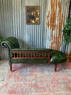 A Victorian-style green leather chaise longue