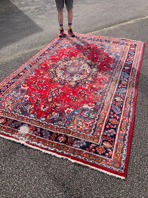 A large red ground Persian rug - 299cm x 194cm