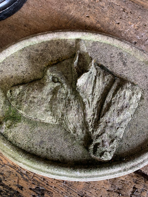 An oval cast stone plaque depicting a dog's head in profile ~C