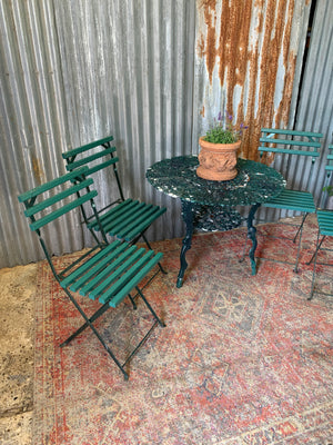 A green garden table and chairs set
