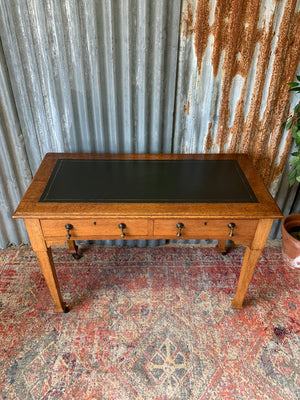 A blonde wood desk on castors