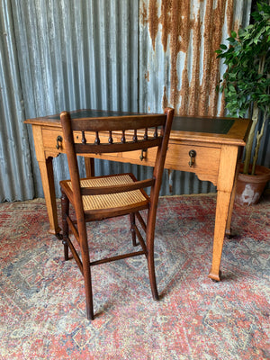 A blonde wood desk on castors