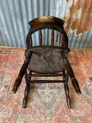 A dark wood captain's chair