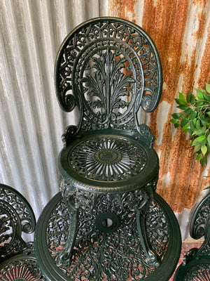 A green garden table and chairs set