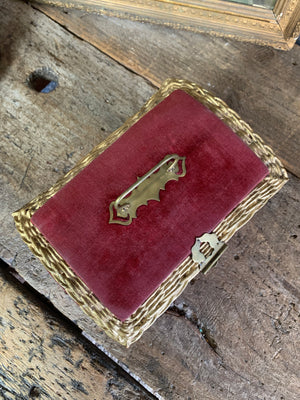 An ornate red velvet casket