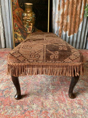 A large Persian carpet footstool