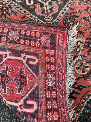 A Persian red ground rectangular rug- 161cm x 117cm