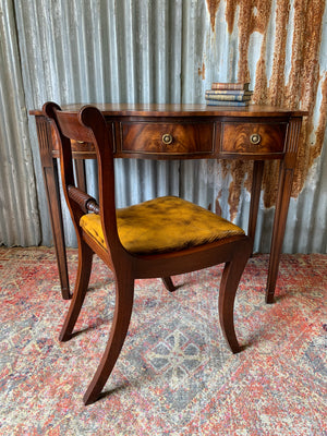 A serpentine desk and leather chair by Bevan Funnell