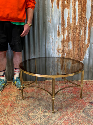 A rare circular brass and glass Hollywood Regency coffee table
