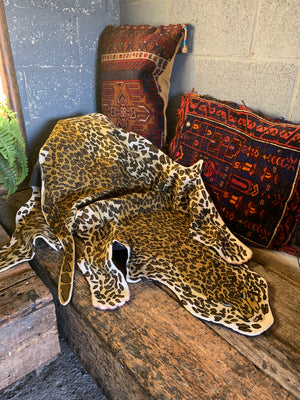 A Liberty of London faux leopard skin rug