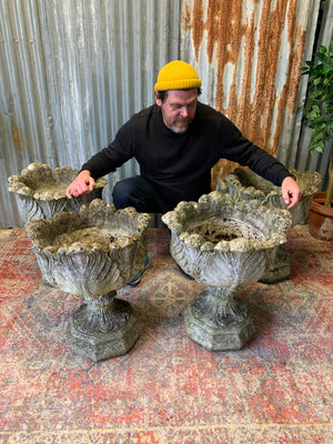 A pair of large acanthus cast stone urns