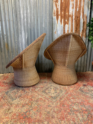 A pair of wicker egg chairs