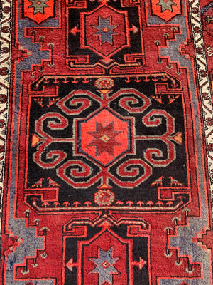 A Turkish red ground rug ~ 211cm x 138cm