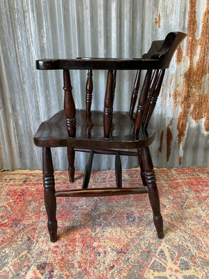 A dark wood captain's chair