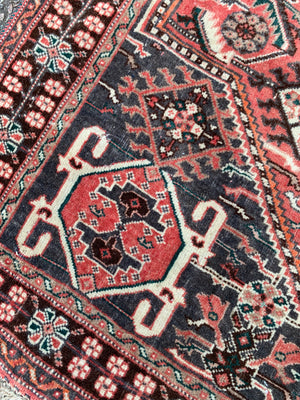 A Persian red ground rectangular rug- 161cm x 117cm