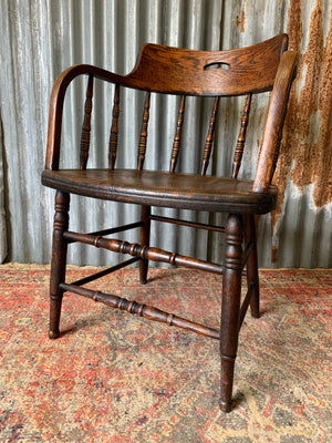 An oak spindle back captain's chair