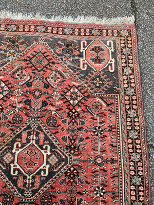 A Persian red ground rectangular rug- 161cm x 117cm