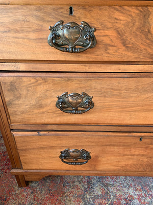 An Art Nouveau chest of drawers