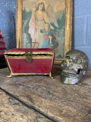 An ornate red velvet casket