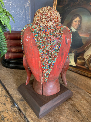 A carved wooden Buddha head